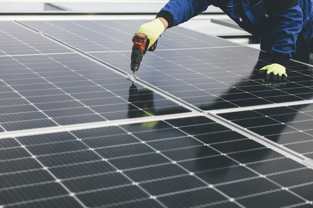 A worker installing a solar panel
