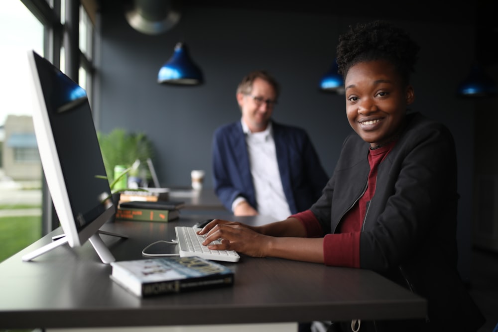 Two colleagues at a desk working in front of a monitor